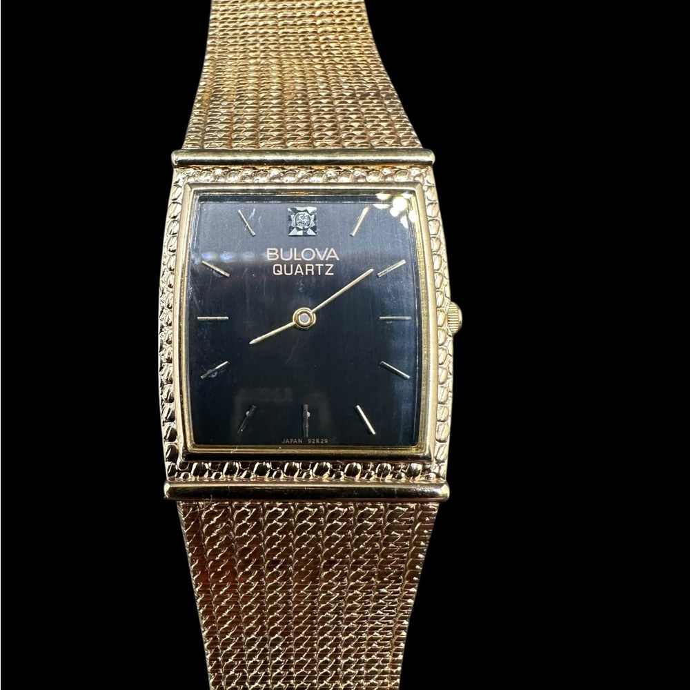 Bulova Men's Gold Tone Quartz Watch with Black Dial. New old stock. Unused